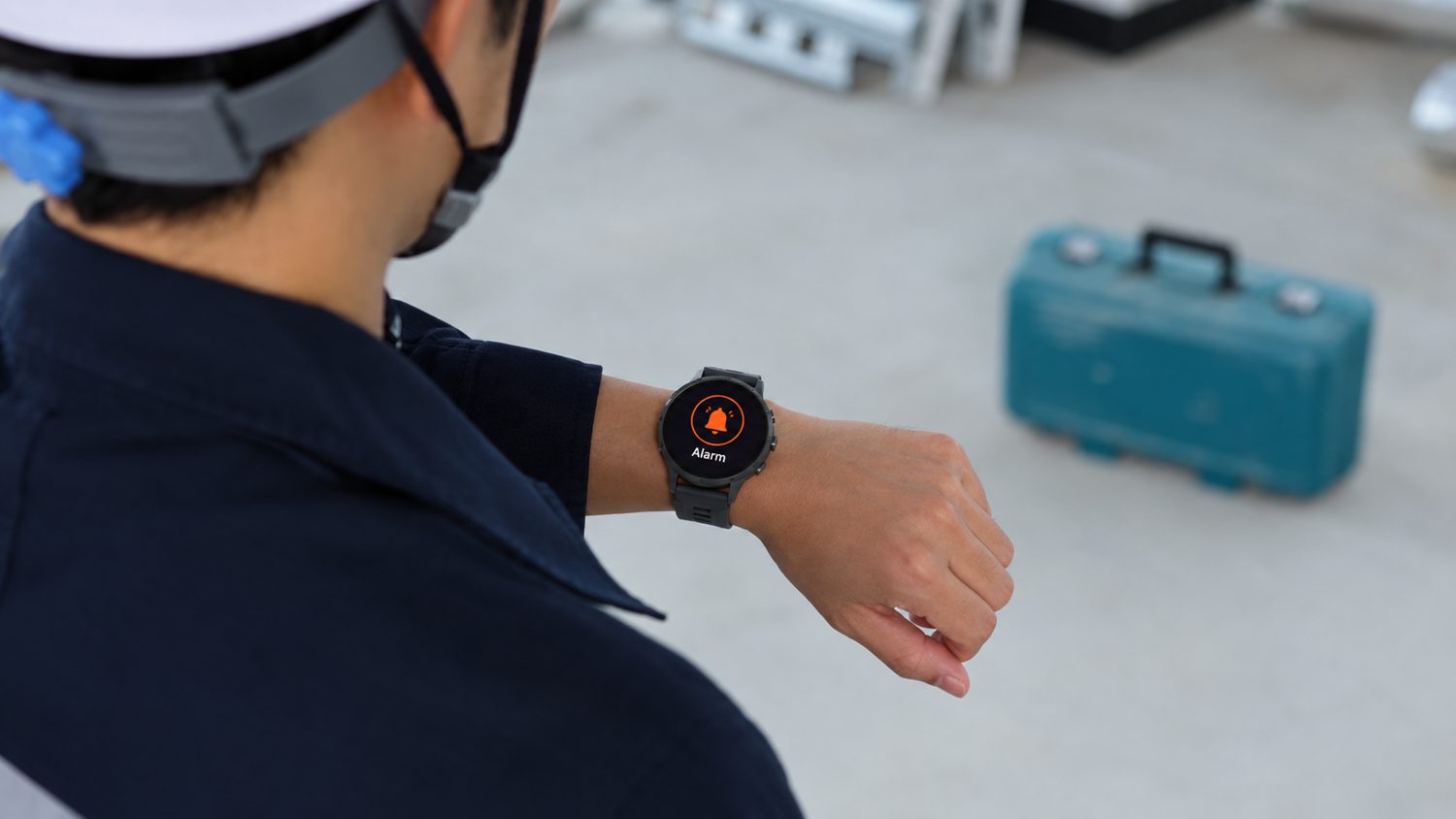 Site worker checking a safety alert on a wrist-worn wearable